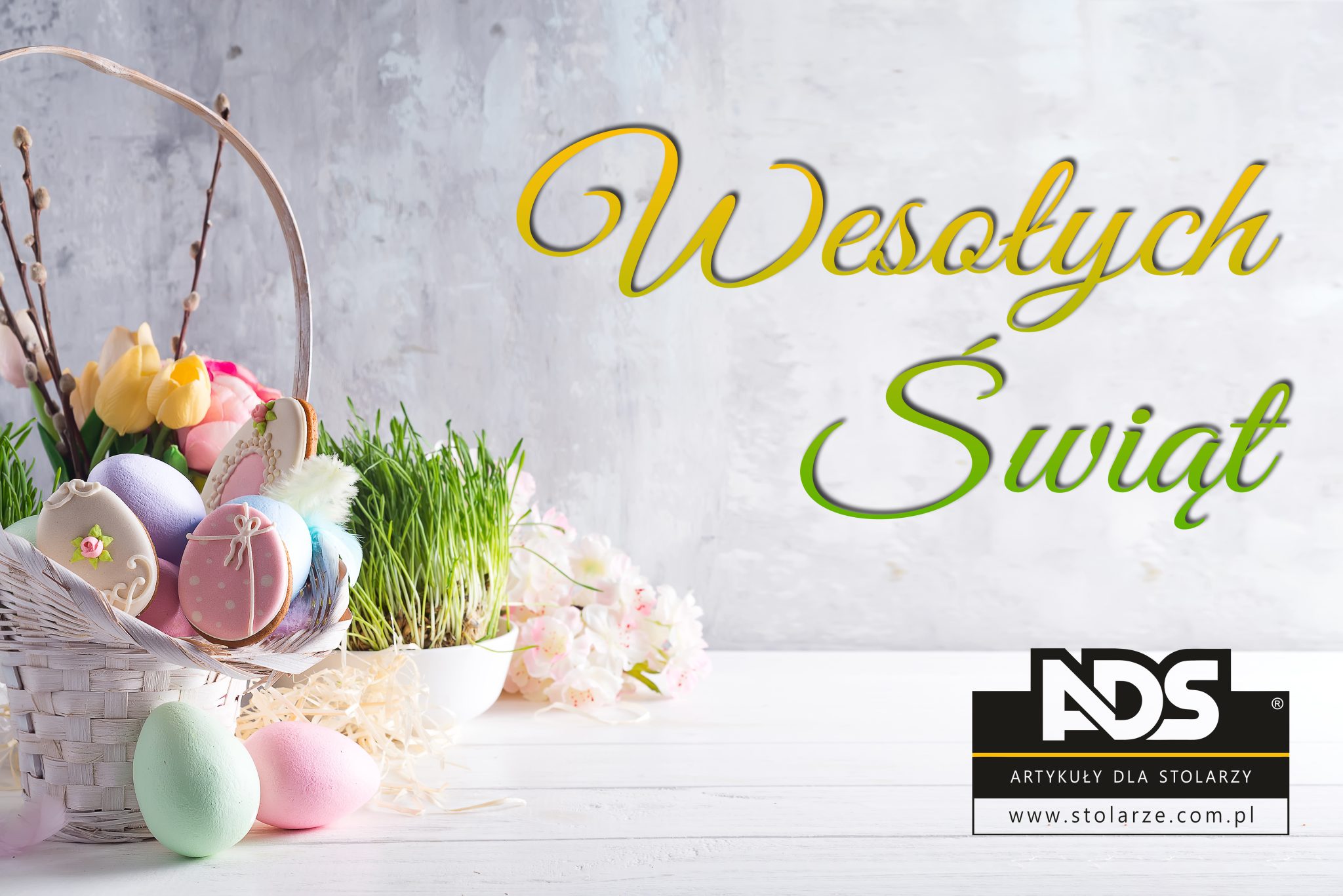 Easter greeting card with gingerbread cookies and colorful easter eggs in basket in front of stone wall. With space for your greetings